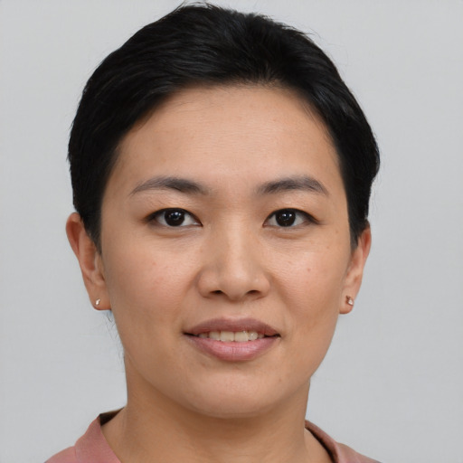 Joyful asian young-adult female with short  brown hair and brown eyes