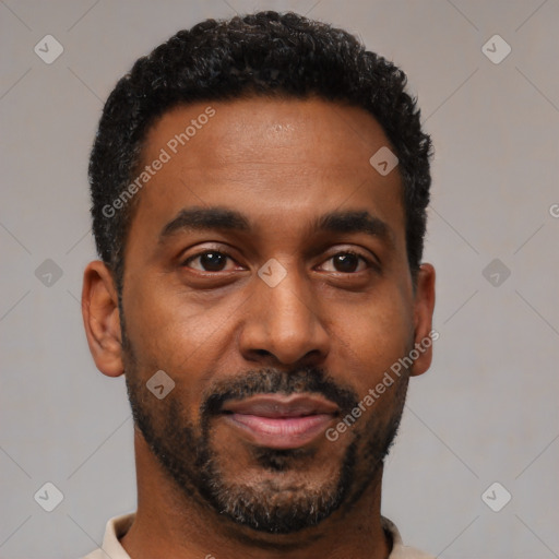 Joyful black young-adult male with short  black hair and brown eyes