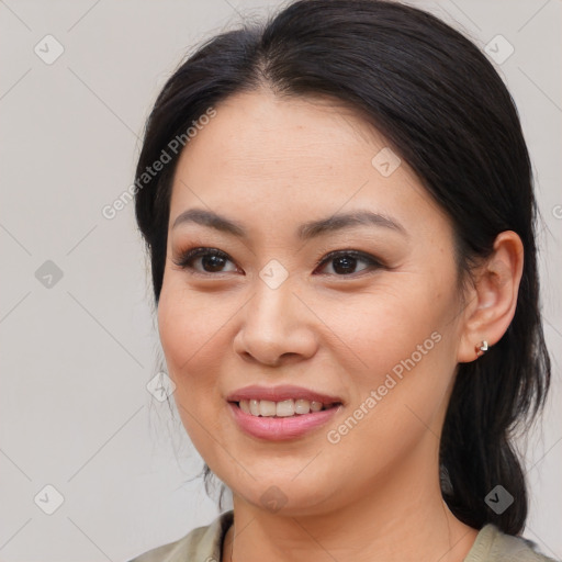 Joyful asian young-adult female with medium  brown hair and brown eyes