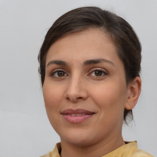 Joyful white young-adult female with medium  brown hair and brown eyes