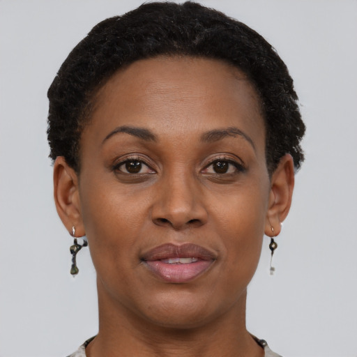 Joyful black adult female with short  brown hair and brown eyes