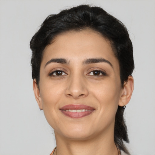 Joyful latino young-adult female with medium  black hair and brown eyes