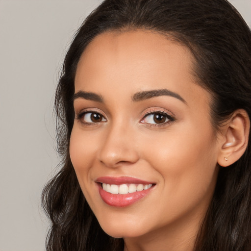 Joyful white young-adult female with long  brown hair and brown eyes