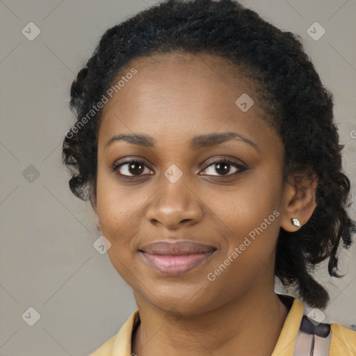 Joyful black young-adult female with long  black hair and brown eyes