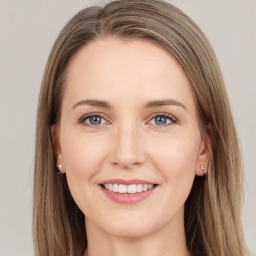 Joyful white young-adult female with long  brown hair and grey eyes