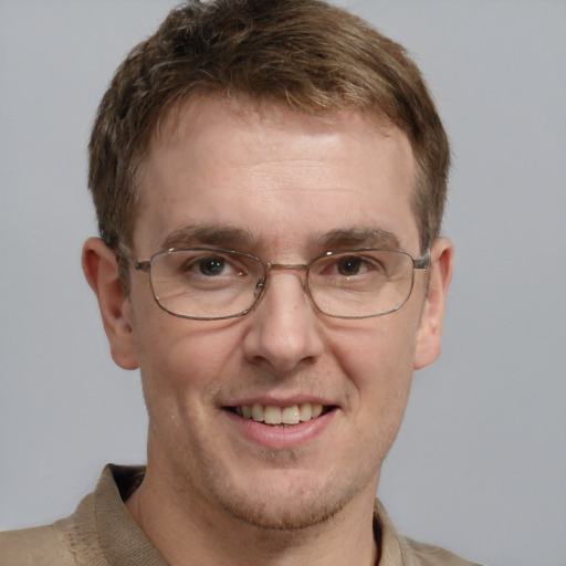 Joyful white adult male with short  brown hair and grey eyes