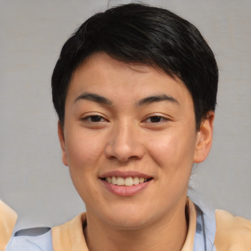 Joyful asian young-adult female with medium  brown hair and brown eyes