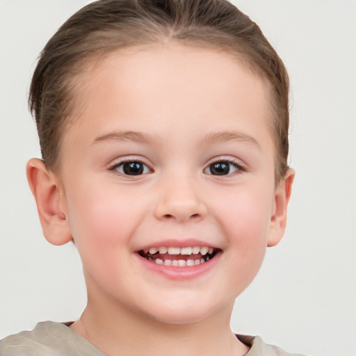 Joyful white child female with short  brown hair and brown eyes