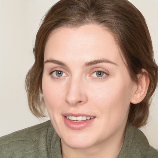 Joyful white young-adult female with medium  brown hair and green eyes