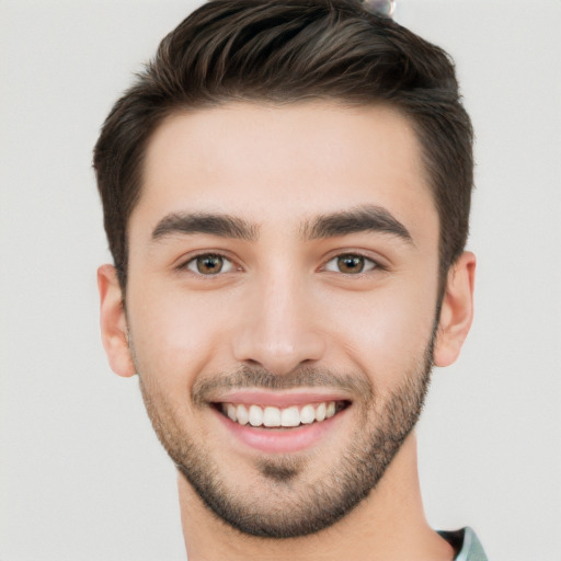 Joyful white young-adult male with short  brown hair and brown eyes