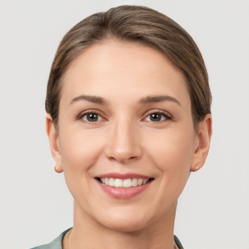 Joyful white young-adult female with short  brown hair and brown eyes