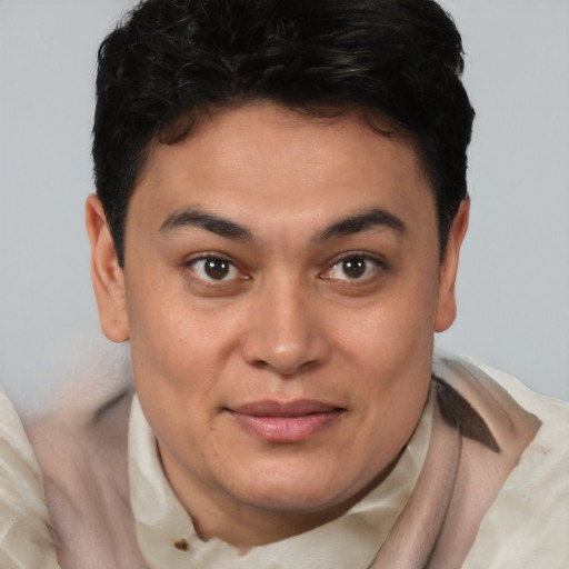Joyful latino young-adult male with short  brown hair and brown eyes