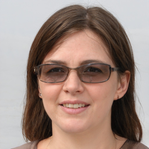 Joyful white young-adult female with medium  brown hair and blue eyes