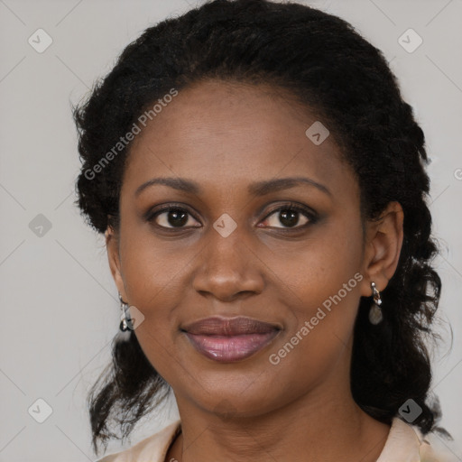 Joyful black young-adult female with long  black hair and brown eyes