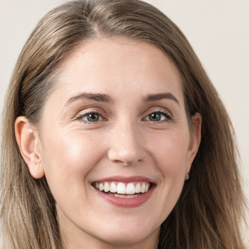 Joyful white young-adult female with long  brown hair and grey eyes