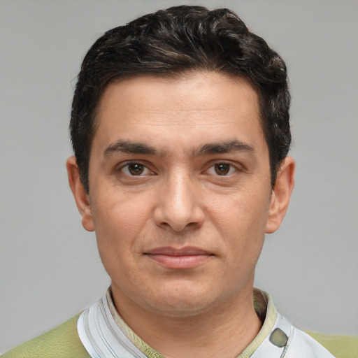 Joyful white adult male with short  black hair and brown eyes