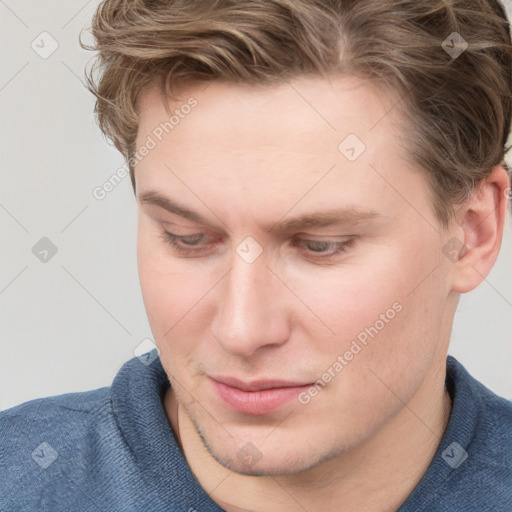 Joyful white young-adult male with short  brown hair and blue eyes