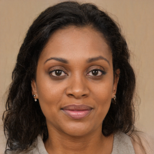 Joyful black young-adult female with medium  brown hair and brown eyes