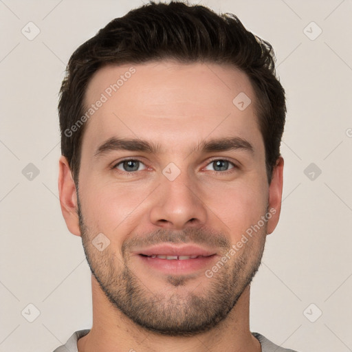 Joyful white young-adult male with short  brown hair and grey eyes