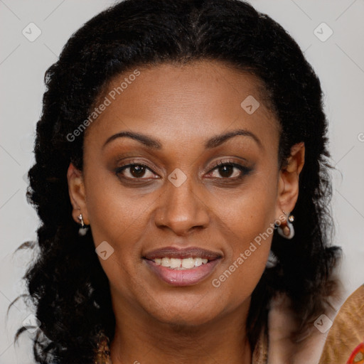 Joyful black adult female with long  brown hair and brown eyes