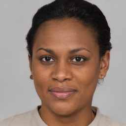 Joyful black young-adult female with short  brown hair and brown eyes