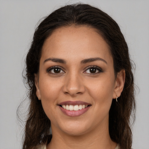 Joyful white young-adult female with long  brown hair and brown eyes