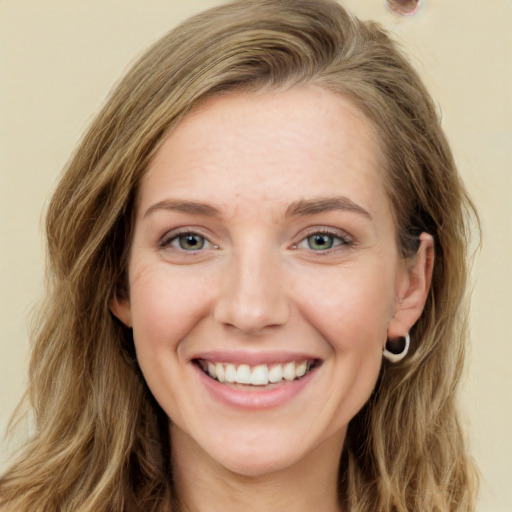 Joyful white young-adult female with long  brown hair and green eyes