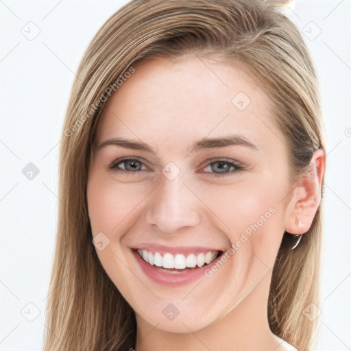 Joyful white young-adult female with long  brown hair and blue eyes