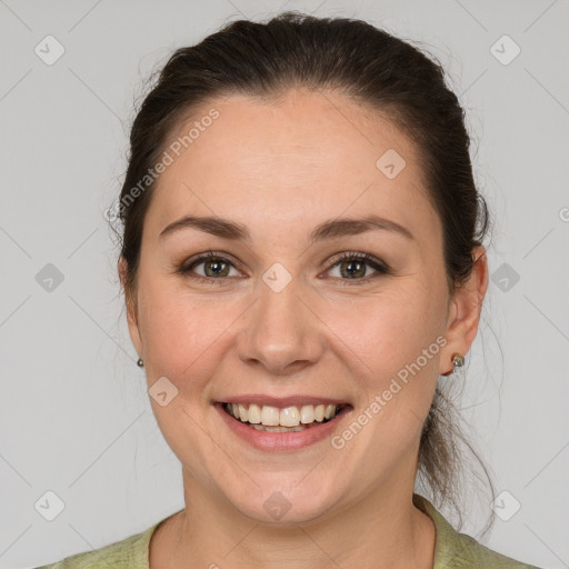 Joyful white young-adult female with medium  brown hair and grey eyes