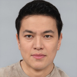 Joyful asian young-adult male with short  black hair and brown eyes