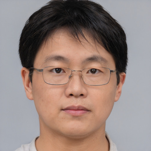 Neutral asian adult male with short  brown hair and brown eyes