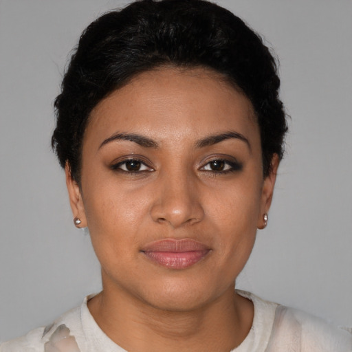 Joyful latino young-adult female with short  black hair and brown eyes