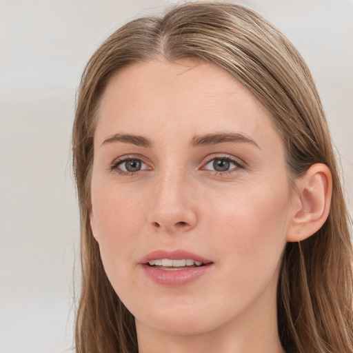 Joyful white young-adult female with long  brown hair and grey eyes