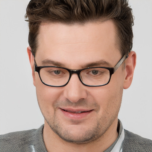 Joyful white adult male with short  brown hair and grey eyes