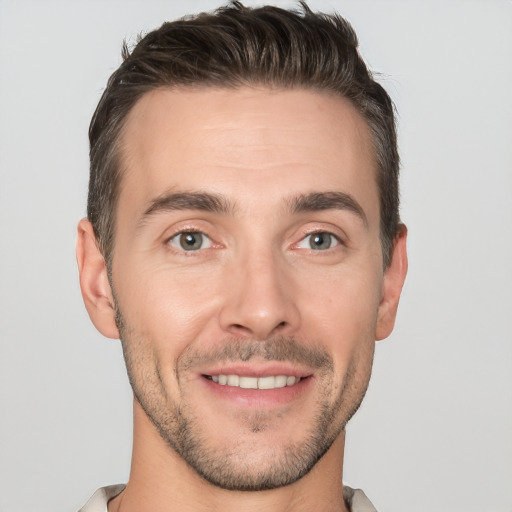 Joyful white young-adult male with short  brown hair and brown eyes