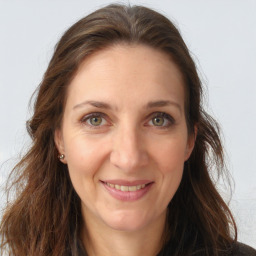 Joyful white adult female with long  brown hair and brown eyes