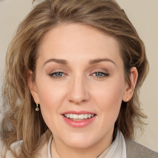 Joyful white young-adult female with medium  brown hair and blue eyes