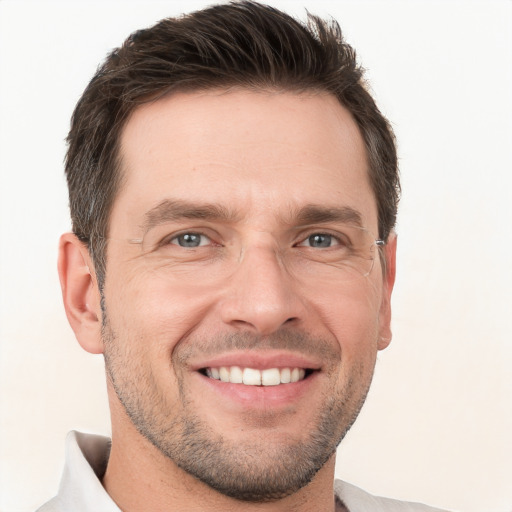 Joyful white adult male with short  brown hair and brown eyes