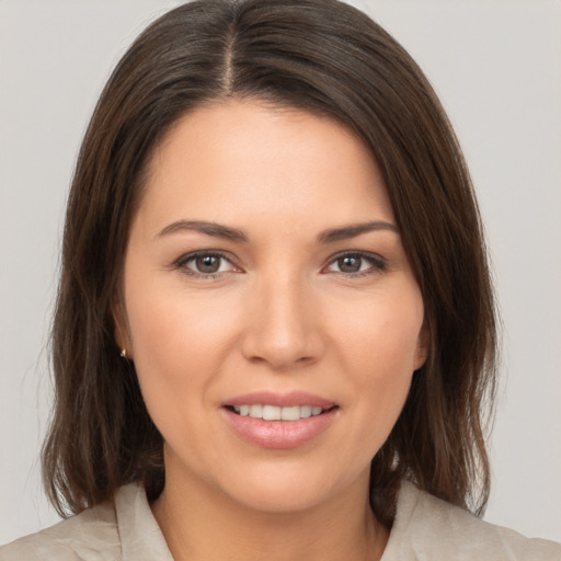 Joyful white young-adult female with medium  brown hair and brown eyes