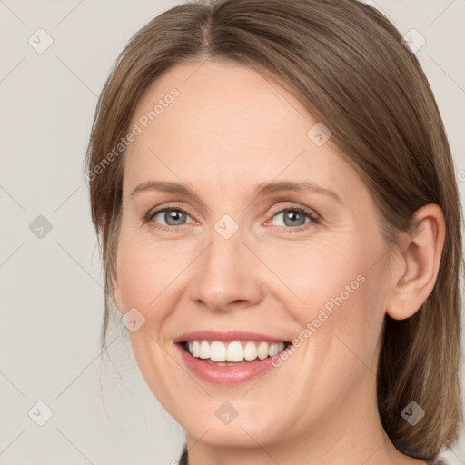 Joyful white adult female with medium  brown hair and grey eyes