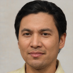 Joyful asian adult male with short  brown hair and brown eyes