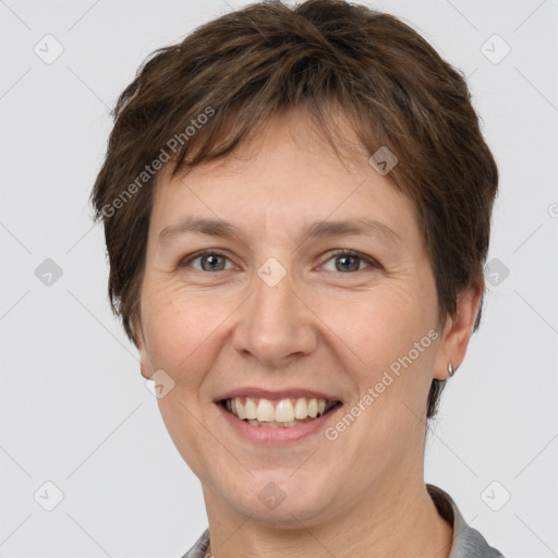 Joyful white adult female with short  brown hair and grey eyes