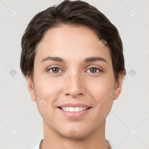 Joyful white young-adult female with short  brown hair and grey eyes