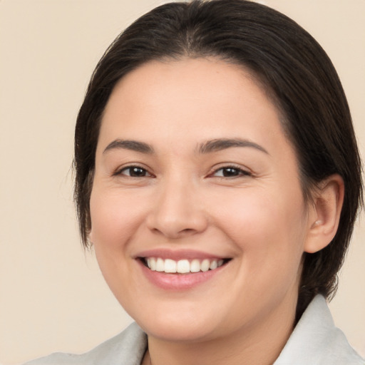 Joyful white young-adult female with medium  brown hair and brown eyes