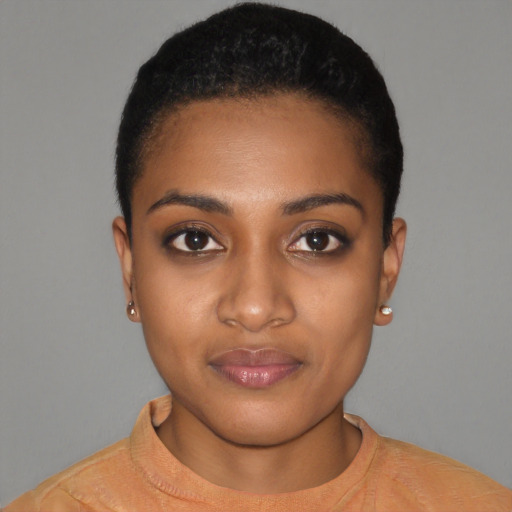 Joyful black young-adult female with short  black hair and brown eyes