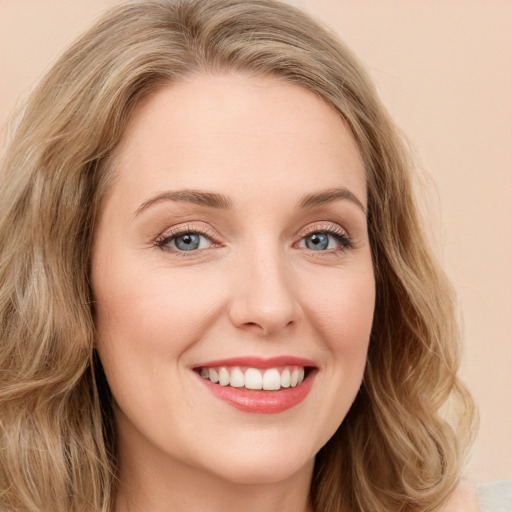 Joyful white young-adult female with long  brown hair and green eyes