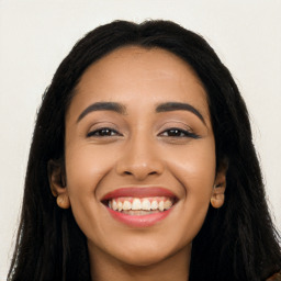 Joyful latino young-adult female with long  black hair and brown eyes