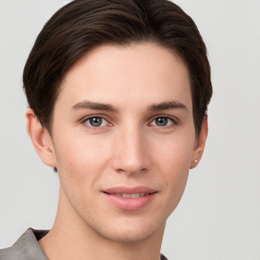 Joyful white young-adult female with short  brown hair and grey eyes