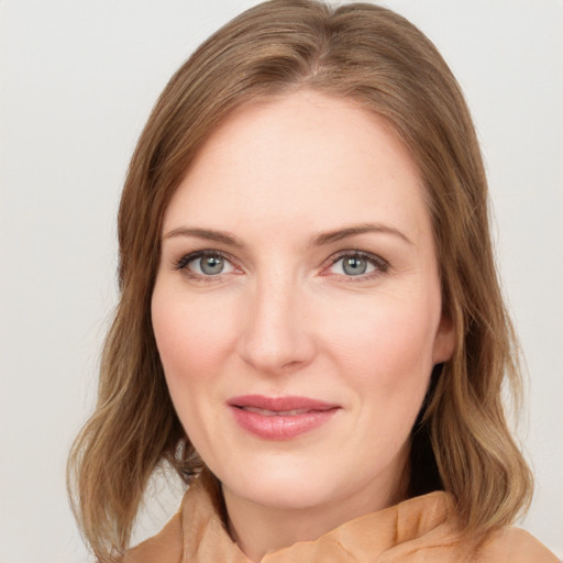 Joyful white young-adult female with medium  brown hair and green eyes