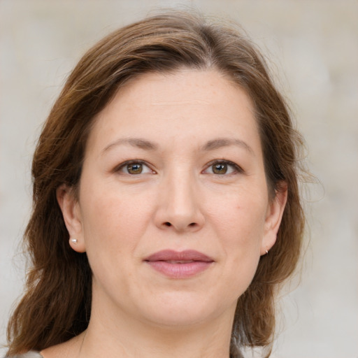 Joyful white adult female with medium  brown hair and grey eyes